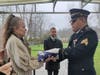 Dawn Tabish, Hannah Symanski's mother, accepts the flag that draped Edwin Basterl's coffin, at the Brig. General William C. Doyle New Jersey Veterans Memorial Cemetery in Wrightstown.
