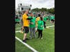 A student interviews Superintendent Thomas Farrell during the game. 