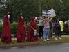 Some protesters dressed in the costumes of "The Handmaid's Tale," a dystopian 1985 novel by Margaret Atwood where fertile women are forced to be surrogates for ruling class families who are infertile. 