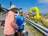 Sandy Rinderer speaks with a participant in the Paddle on the Bay world-record kayak and canoe parade attempt. Rinderer was able to join in and paddle the course along with the other entrants.