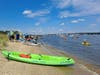 Some kayakers prepare to launch while others pack up after participating in the Paddle on the Bay world-record kayak and canoe parade attempt.