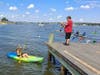 A kayaker gets her participation in the Paddle on the Bay world-record kayak and canoe parade attempt captured for a memory of the day.