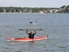 A participant in the Paddle on the Bay world-record kayak and canoe parade attempt celebrates as he nears the completion of the course. 