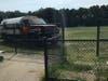 The truck was left sitting on the baseball field at the school.