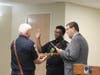 Mayor Robert Hudak administers the oath to firefighter/EMT Nathan Brown as Fire Capt.  Roger Brown looks on.