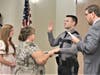 Patrolman Joseph Stapleton takes the oath with his family watching.