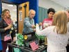 Students operating the Mustang Joe's Coffee Cart deliver orders to staff members at Manchester Township Middle School. The cart operates every Thursday morning.