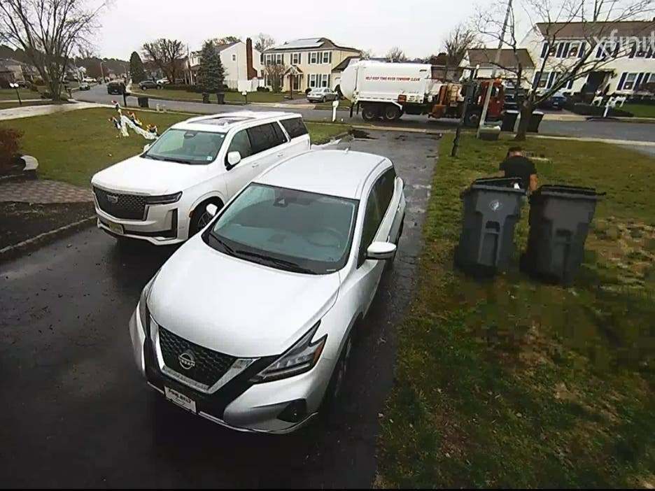 A Toms River garbage collector wheels the Cirillo family's garbage cans to the curb to be emptied. "He made our day," Erica Cirillo said. 