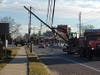 Another view of the small excavator tangled in power lines on Hooper Avenue in Toms River on Friday. 