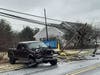 A pickup truck sits on the side of Route 88 after it hit a utility pole and brought down wires. 