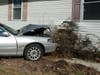 The Lincoln Town Car hit a house on Ridgeway Road after hitting a mailbox and a utility pole, Manchester police said. 