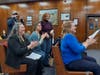 Julie Gaffney (standing) and Victoria Gianakos (seated next to Gaffney) and Brick Township Planner Tara Paxton (black jacket) applaud the unanimous approval by the Ocean County Board of Commissioners to spend $6.84 million for the Breton Woods site.