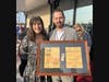 Brick Mayor Lisa Crate with Dan Holland, Wawa area manager, with a framed copy of an advertisement from the grand opening of the original store that stood at the Lanes Mill site, from 1982. 
