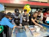 Brick Township Mayor Lisa Crate (center) competes with the Brick Township Police team in the Hoagies for Heroes competition at the grand opening of the Wawa on Lanes Mill Road. 