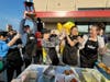Brick Township Mayor Lisa Crate (center) high-fives a teammate on the Brick Township Police team after they won the Hoagies for Heroes competition at the grand opening of the Wawa on Lanes Mill Road. 