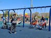 Families take advantage of swings designed for children with physical challenges at the Field of Dreams in Toms River. 