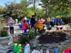 Manchester students prepare to plant flowers and do other work to clean up the Children's Memorial Garden at Winding River Park in Toms River. 