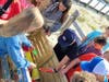 Students from Emma Havens Young Elementary School show off the toys in a shareable toy bin at Brick Beach III. 