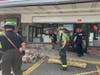 Firefighters from the Laurelton and Herbertsville fire companies clean up debris after a vehicle smashed into the front of the 7-Eleven at the corner of Burnt Tavern Road and Burrsville Road on Monday morning. 