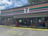 Damage to the front of the 7-Eleven is assessed. 