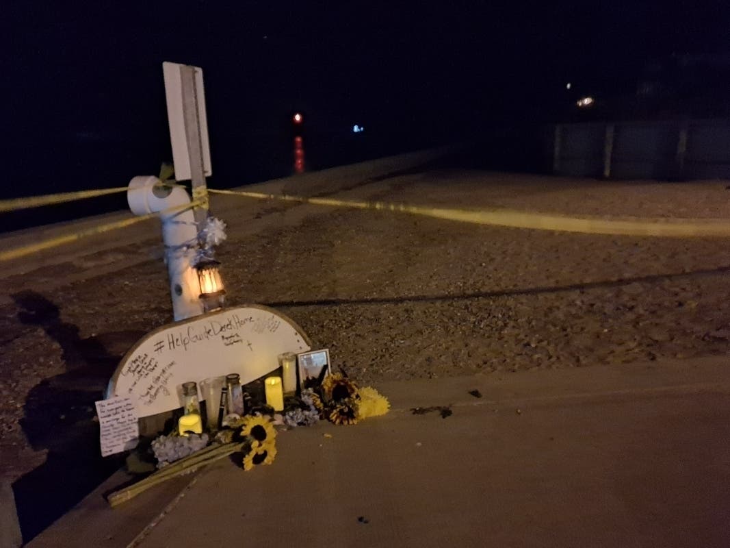 A memorial to Derek Narby, 21, of Brick, at Manasquan Inlet. In the distance the red beacon marks the mouth of the inlet, where the boat was swamped by a large wave.