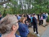 People who attended the anti-bullying rally at Lake Riviera Park gather near the dock to hear the boy's family speak. 