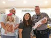 Baby Mia with Dad Nick, Mom D'Kota, sister Lily and Officer Pete Saker.