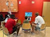 Landon Stockhoff playing Madden football with Rutgers University football players Isaiah Washington and Victor Konopka at Children's Specialized Hospital in New Brunswick. 