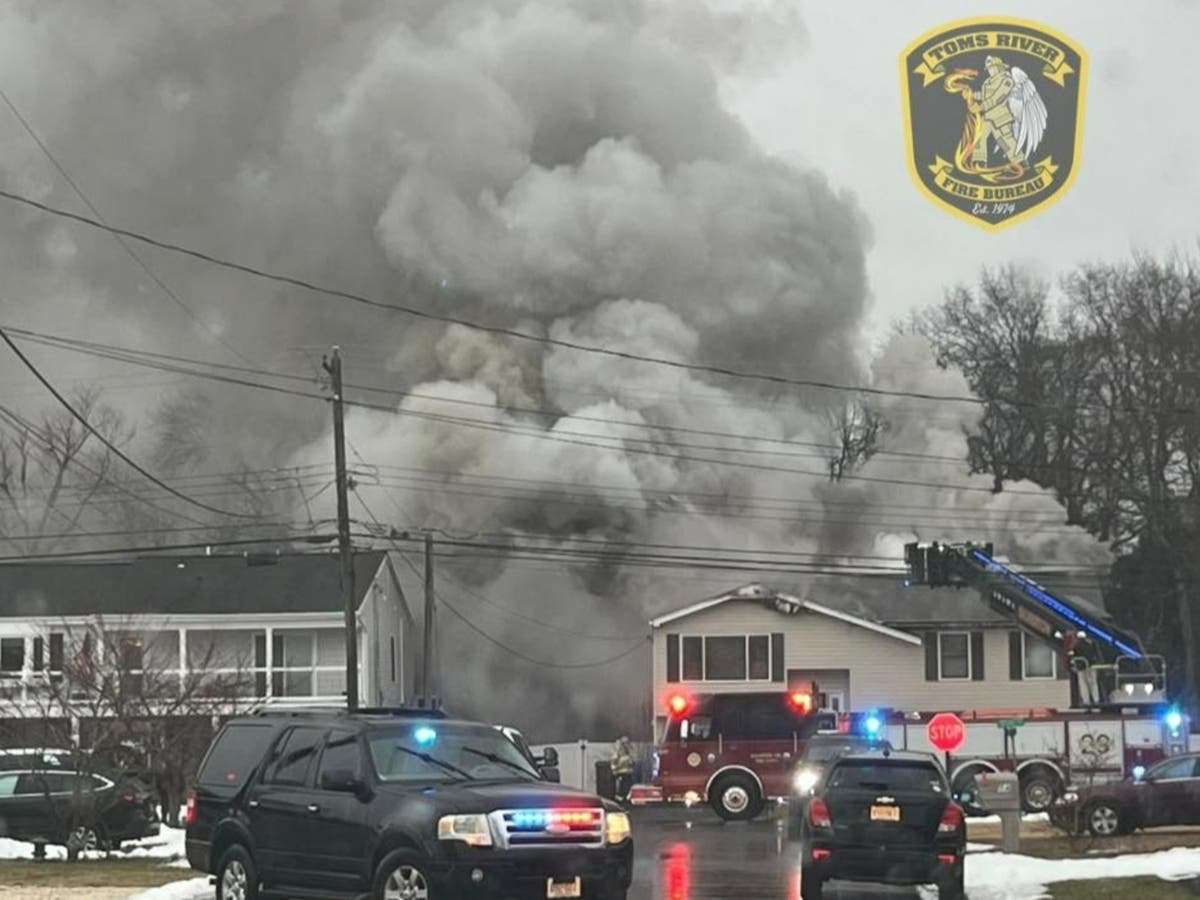 Smoke billows from the back of a home on Aldo Drive in the Silverton section of Toms River on Thursday morning. The family was attending a funeral at the time, a friend said.
