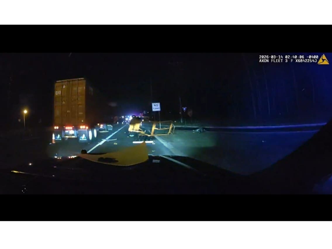 Video shows the aftermath as the truck hits the car that was on the side of the road with its lights activated, South Brunswick police said.