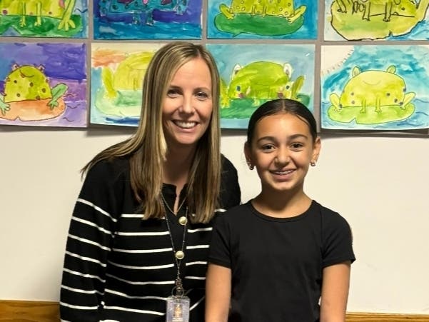 Melissa Nazario and Aliyah Maghrabi, the student who nominated her as an Applebee's Above and BEEyond Teacher. Aliyah's essay was chosen as a winning entry. 