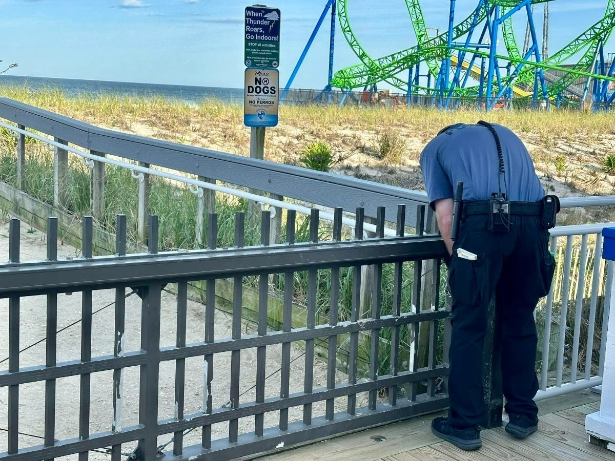 A Seaside Heights police officer locks a beach access gate on the boardwalk on Sunday, May 31, at 6:14 p.m., according to Gregory Andrus. Mayor Anthony Vaz said the gate was not supposed to be closed that early.