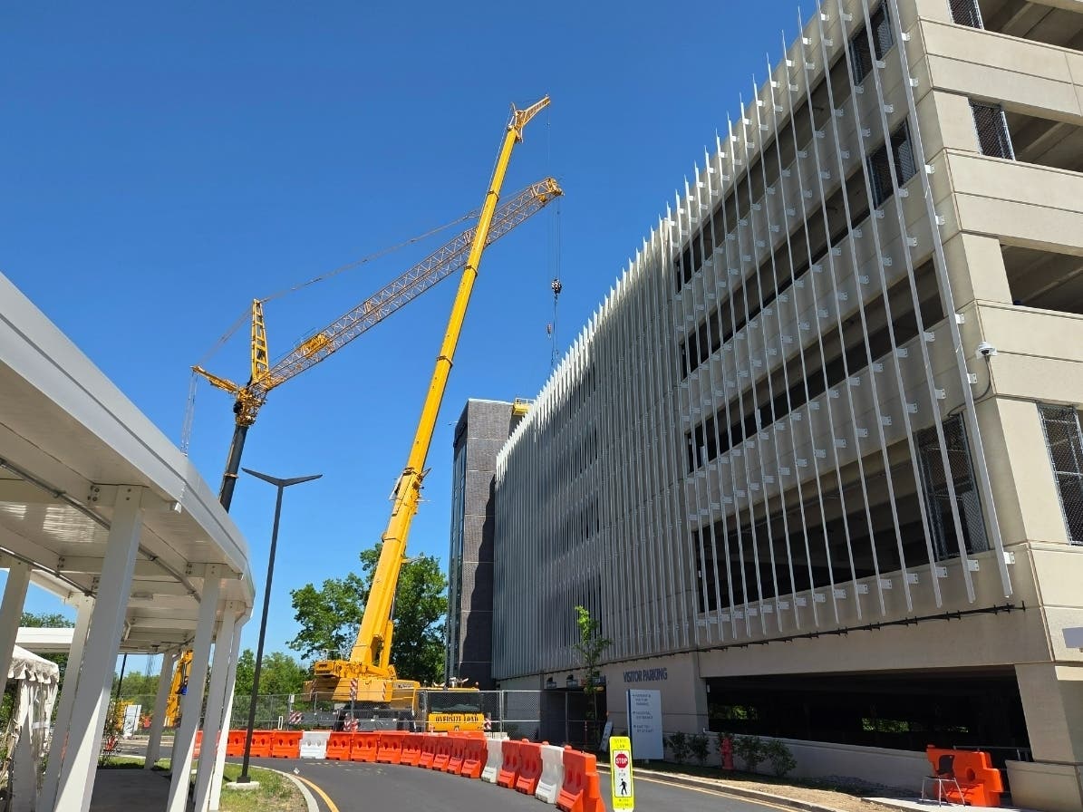 Crews place a concrete slab on the roof of the parking garage at Community Medical Center in Toms River on May 16, part of repairs after the building was found structurally unsafe. 