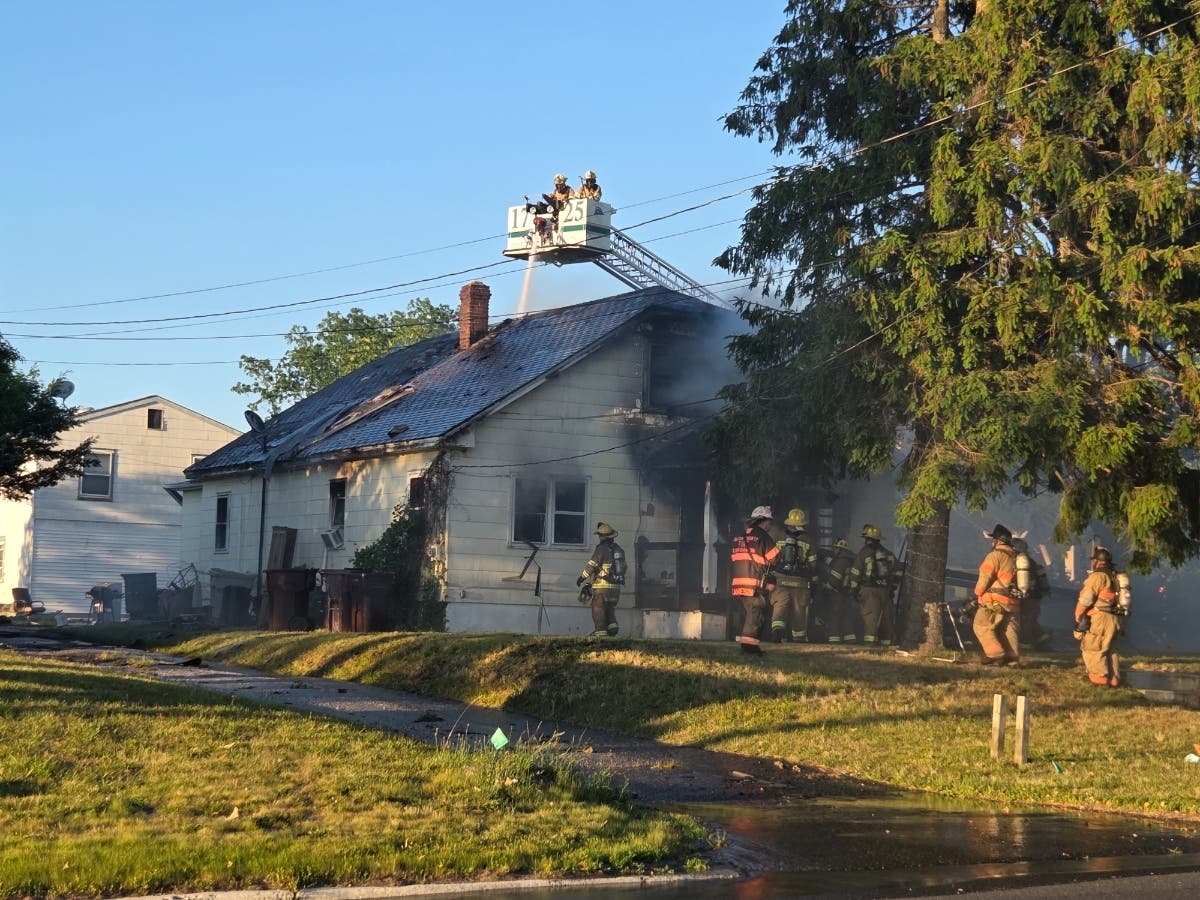 Firefighters pour water on a house fire Sunday in Bayville.