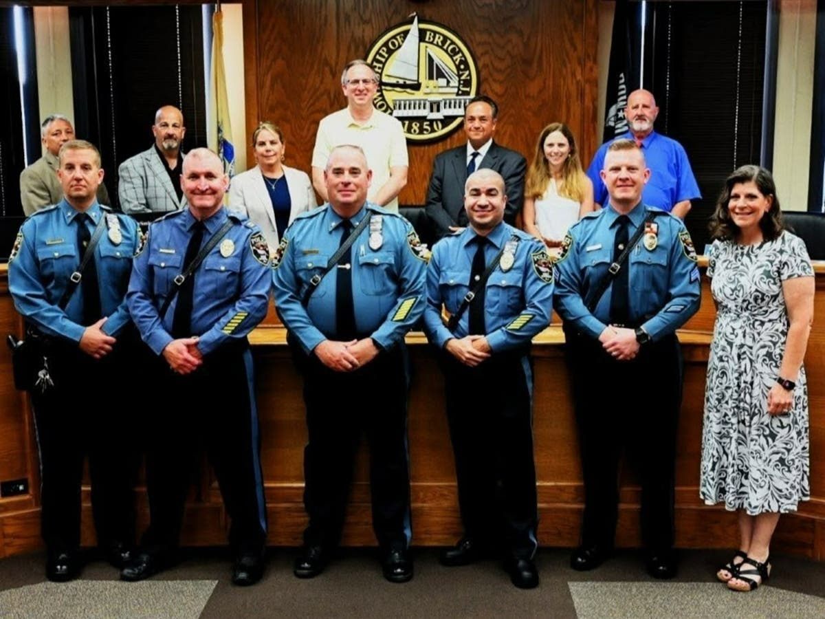 Newly promoted officers Deputy Chief Jason Matthews, Capt. Vincent Coburn, Acting Chief Henry Drew, Lt. William Vendrell, Sgt. Scott Mesmer, Mayor Lisa Crate and the Brick Township Council.