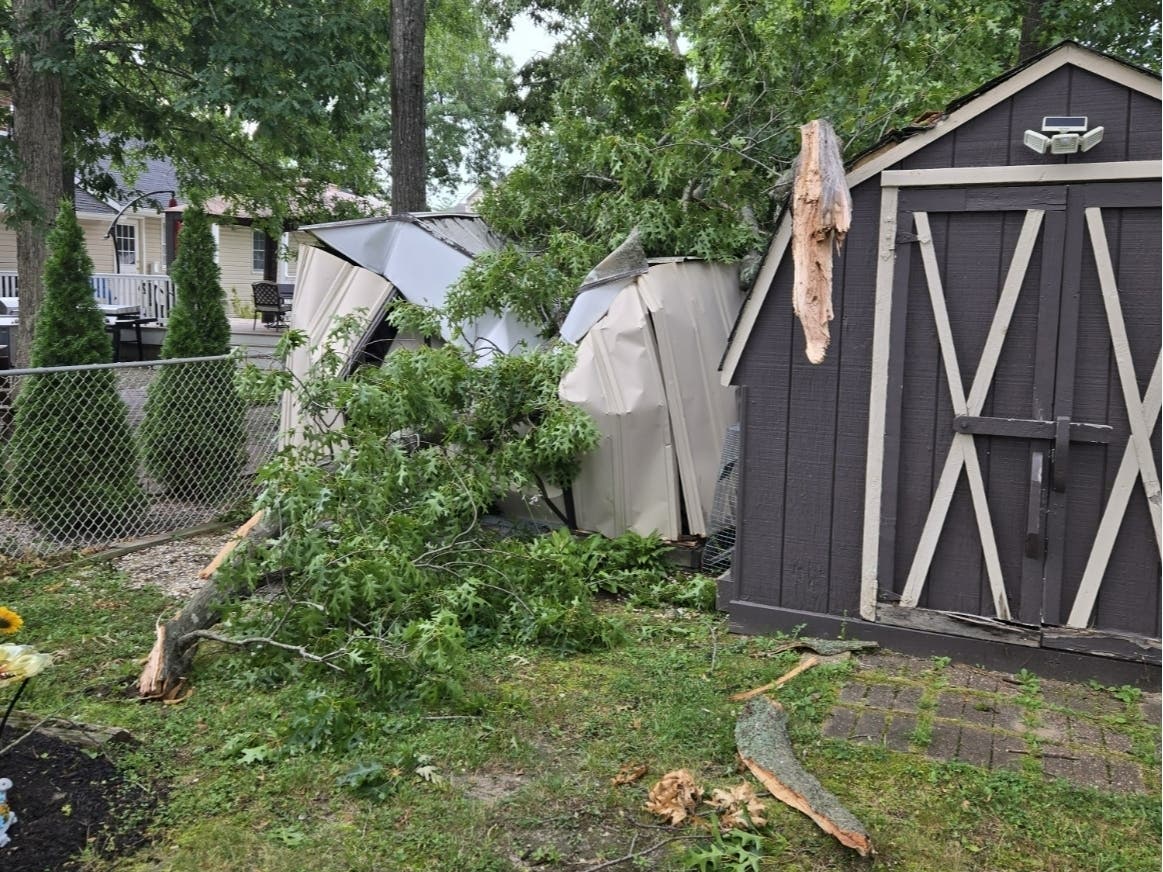 Saturday's storm brought down trees in new areas, including this one on a shed in the Forked River section of Lacey in Ocean County.