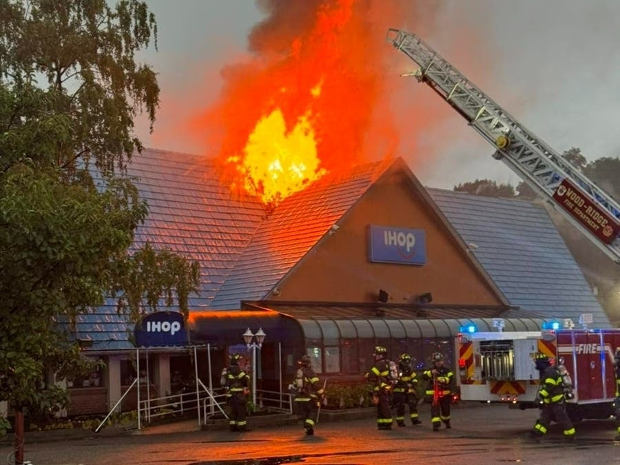 Flames shoot through the roof of the IHOP on Route 17 in Hasbrouck Heights on Monday morning. 