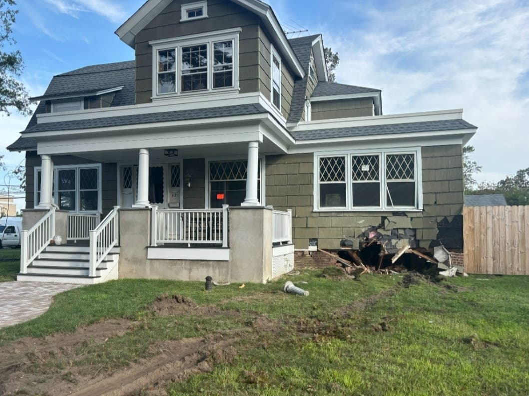 Tire tracks and damage to the foundation can be seen at a home on Union Avenue that was hit by a bus on Thursday.