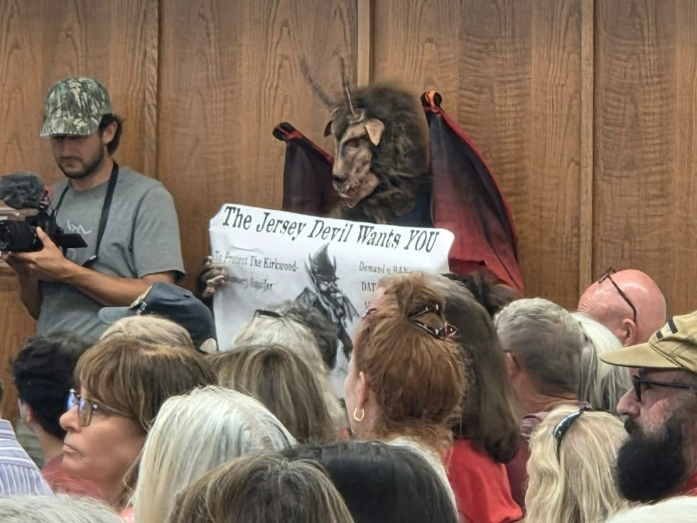 A person dressed as the Jersey Devil at the Aug. 24 Manchester Township Council meeting, which had an overflow crowd opposing AI data centers. The Sept. 14 meeting has been moved to Manchester Township High School.