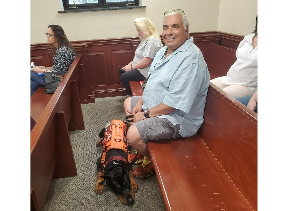 Carl Monto in court with Maverick after he was ticketed in May 2025 for having the dog on the boardwalk in Seaside Heights. He has been arrested three times since and is suing the borough.