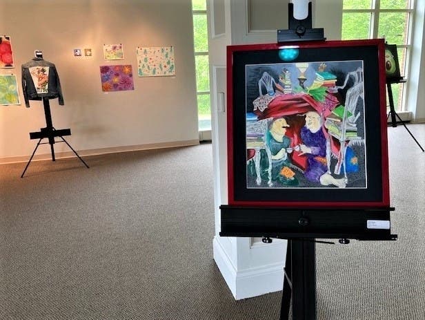 Woodlands Academy’s Gloria Dei Center provided a beautiful venue for this year’s Fine Arts Evening, open to viewing only by students, faculty and staff due to COVID-19. Shown in the foreground is an acrylic painting by senior Safia Karimi.

