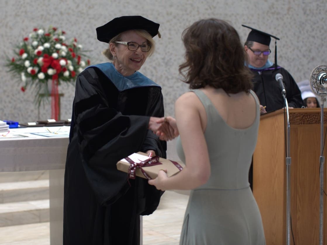 Head of School Dawn Nichols, Ph.D., gives an award to junior Eleanor Proctor during the annual Honors Recognition ceremony at Woodlands Academy, an all-girls college-prep day-and-boarding high school in Lake Forest. 