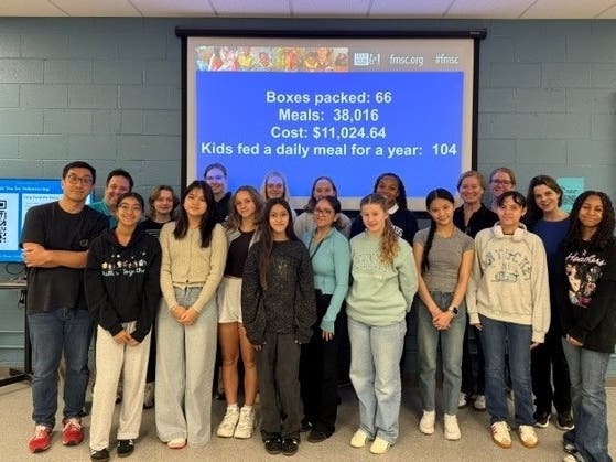 Woodlands Academy freshmen learned about hunger and food scarcity while helping pack food at Feed My Starving Children in Libertyville. The numbers on the screen show the totals they helped achieve as part of the school’s September Service Day.