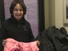 North Shore Civic Ballet board member, Judy Moynihan, shows some outerwear donated to the Marblehead School of Ballet's winter coat drive.