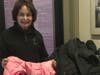 North Shore Civic Ballet board member, Judy Moynihan, shows some outerwear donated to the Marblehead School of Ballet and the ballet company's winter coat drive in a previous collection.  

