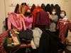 Left to right:  Students Masha Bondarenko, Karen Smith, and Connie Truax show some of the clothes collected to the Marblehead School of Ballet and North Shore Civic Ballet's third annual winter clothing drive.