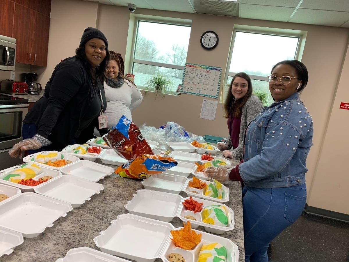 Pictured is a recent photo of volunteers and staff at the Normandy Drop-In Center creating meals for the Epworth community.