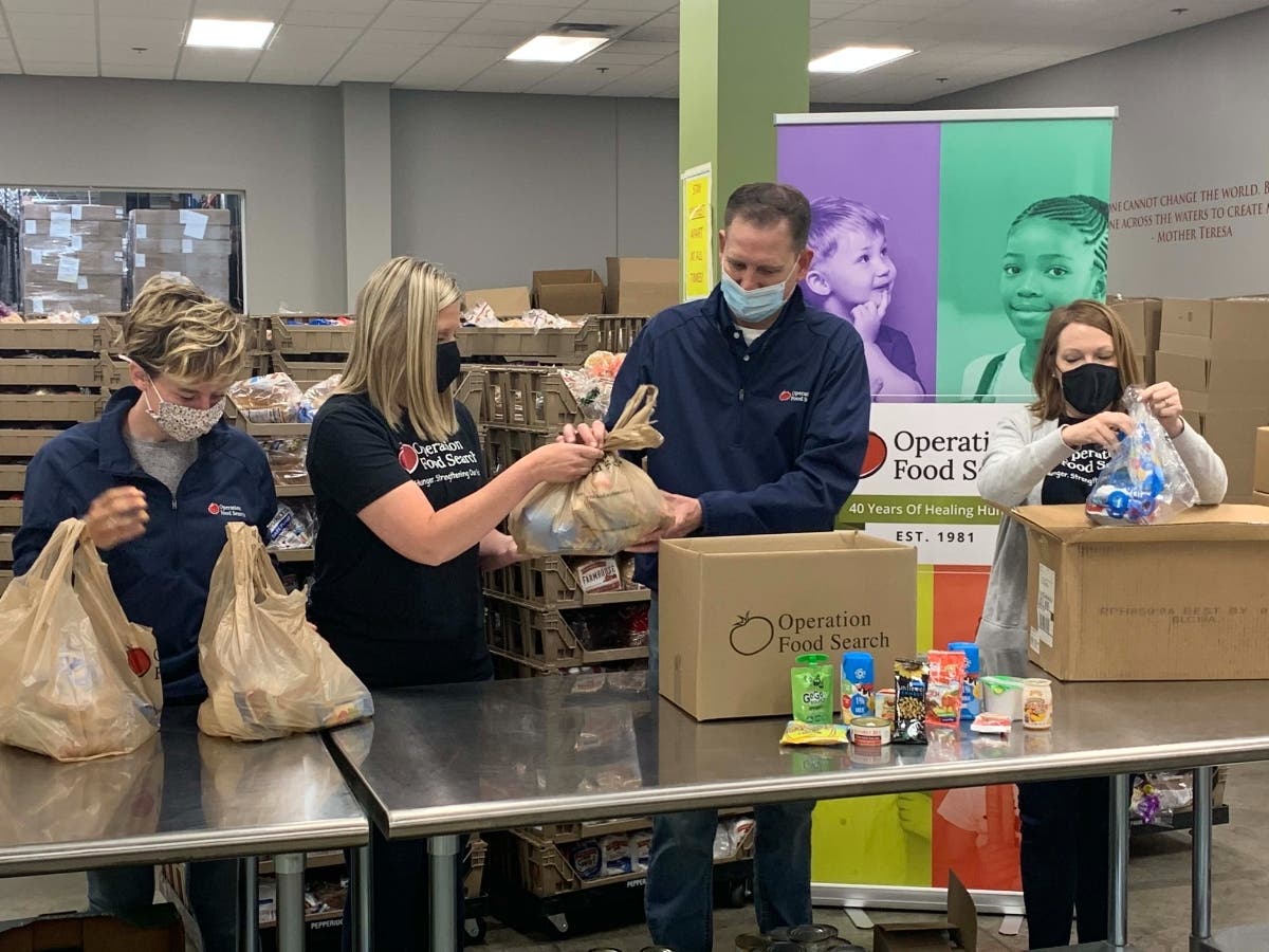 Pictured from left to right are Operation Food Search team members Lucia Burton, Brooklyn Swyers, Brian Wieher and Melissa Weissler. The pictured bag contains two child meals – one breakfast and one lunch.