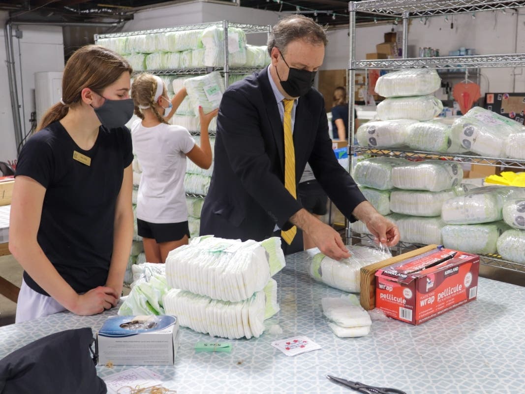 Pictured is Dr. Sam Page with a National Charity League volunteer.