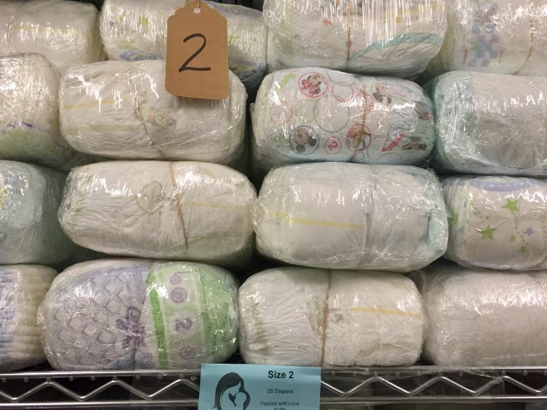 Volunteers are needed to count, sort, and wrap diapers to prepare them for a holiday distribution event.